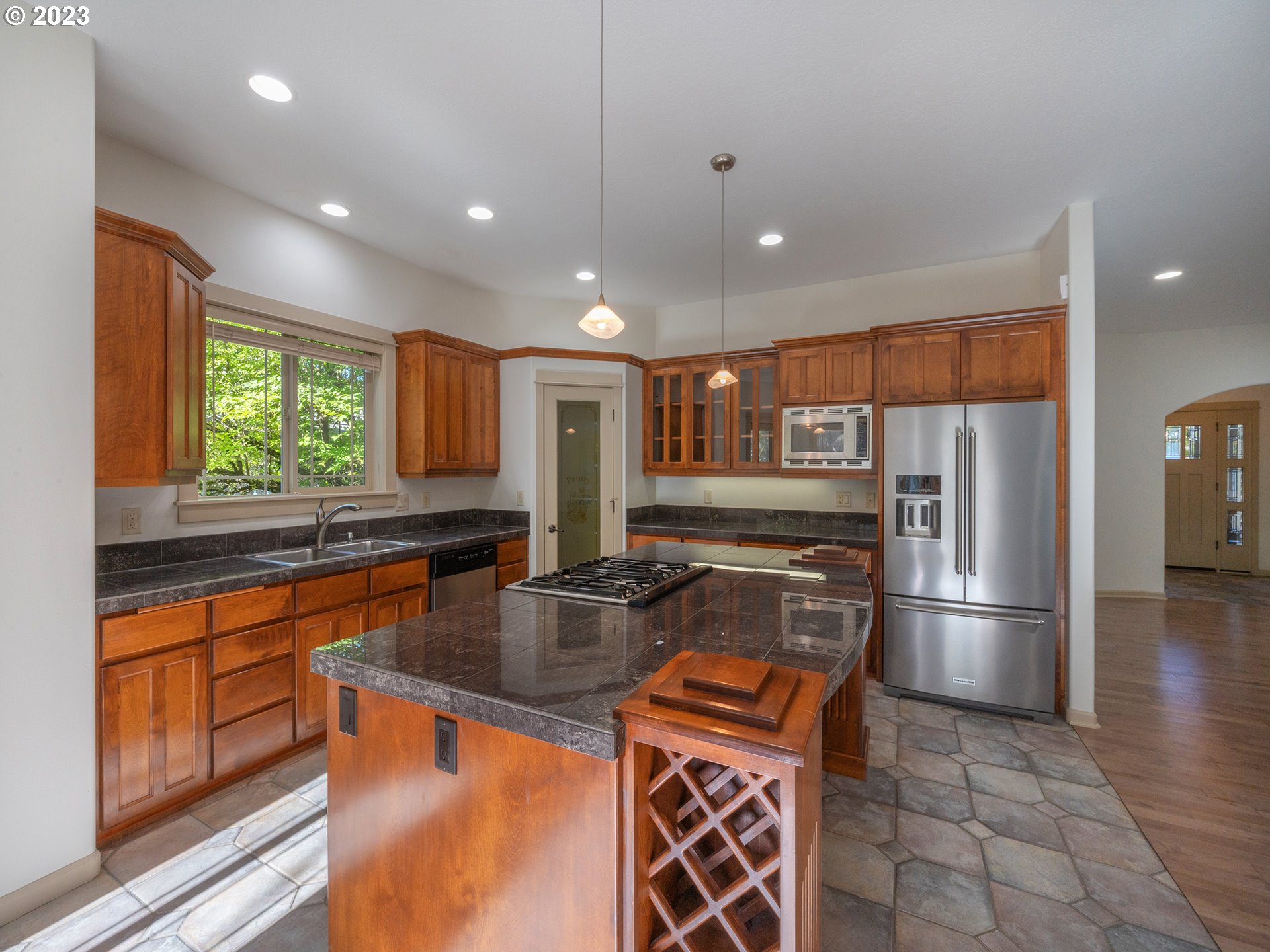 3384 Lakeside Drive Eugene, OR 97401 - Photo 12 of 48 a kitchen with stainless steel appliances granite countertop a refrigerator a sink a stove and island