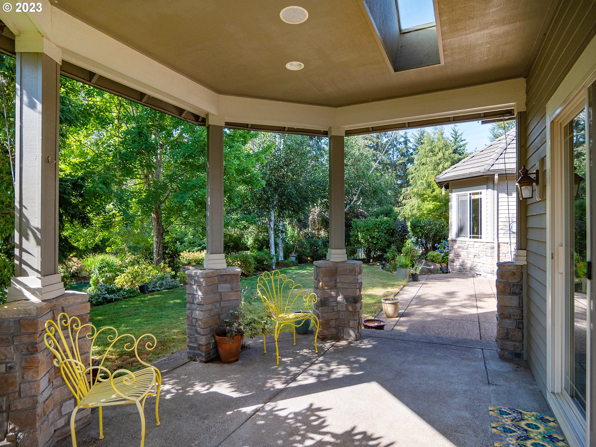 3384 Lakeside Drive Eugene, OR 97401 - Photo 27 of 48 a view of a patio with table and chairs potted plants and floor to ceiling window