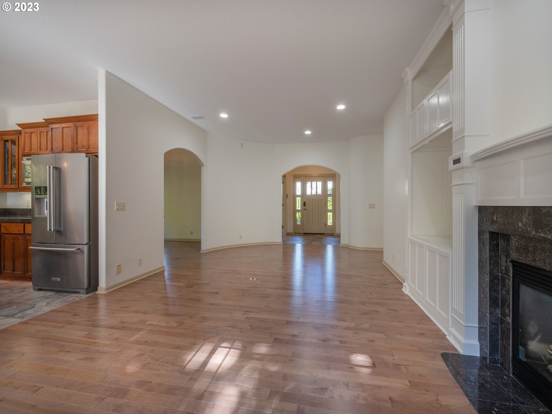 3384 Lakeside Drive Eugene, OR 97401 - Photo 48 of 48 an empty room with wooden floor fireplace and windows