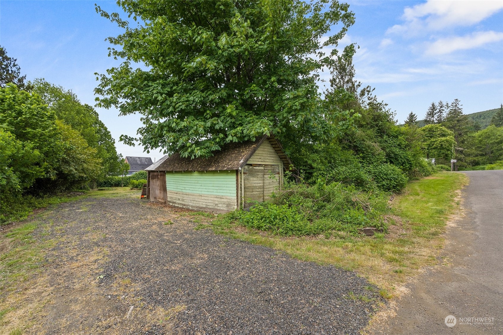 1235 Cedar Street Raymond, WA 98577 - Photo 20 of 23 a small yard with a tree