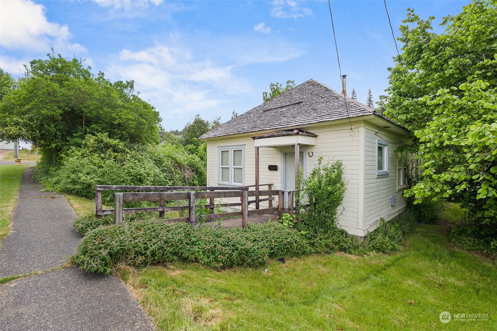 1235 Cedar Street Raymond, WA 98577 - Photo 2 of 23 a front view of a house with a yard