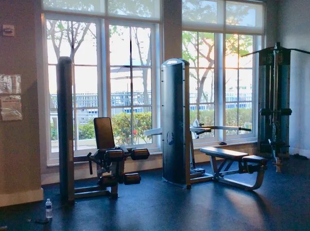 a living room with furniture and floor to ceiling windows