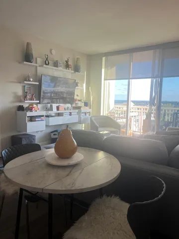 a kitchen with a table chairs and window