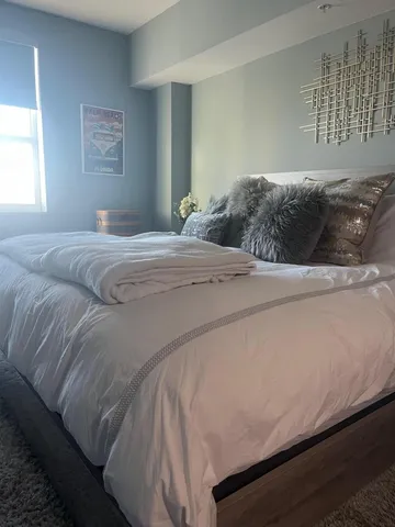 a bedroom with a bed and a window