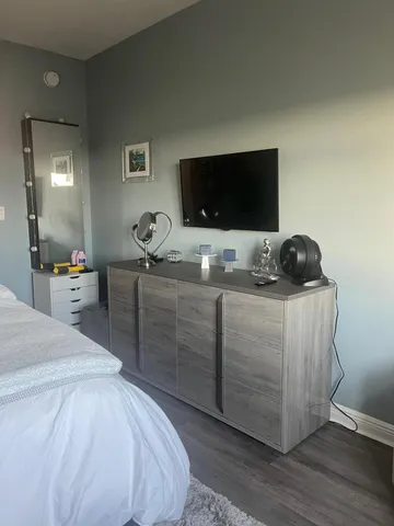 a bedroom with a bed and flat screen tv