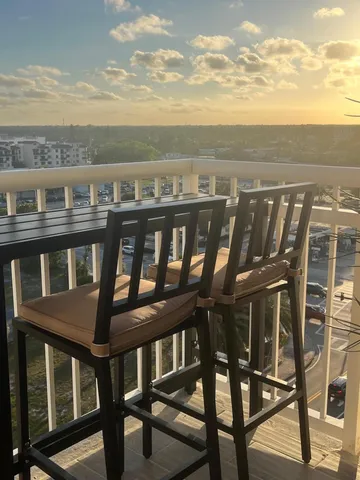 a view of a balcony with an outdoor seating