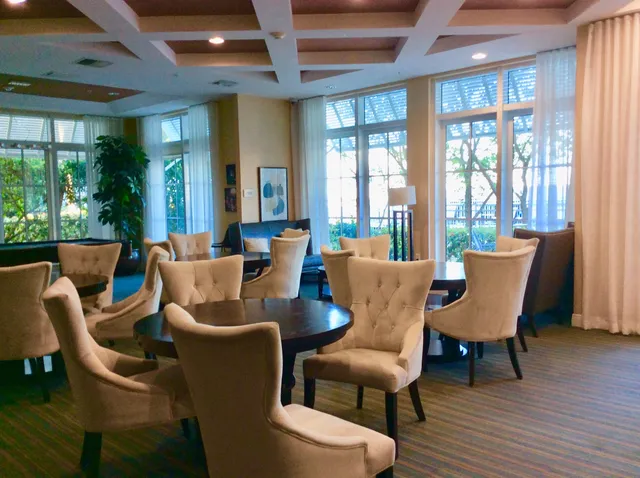 a dining room with furniture a chandelier and wooden floor
