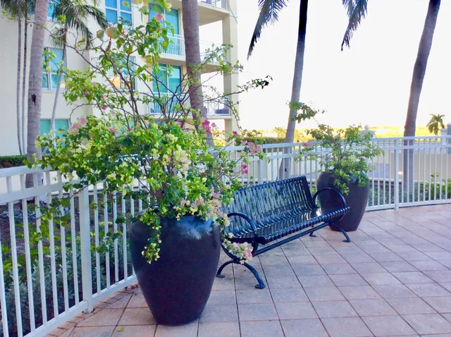 a wooden bench sitting in front of a building