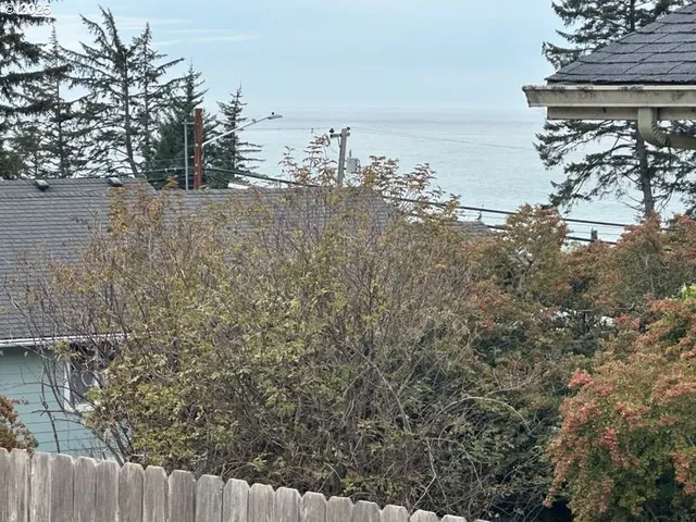 a view of a yard with wooden fence