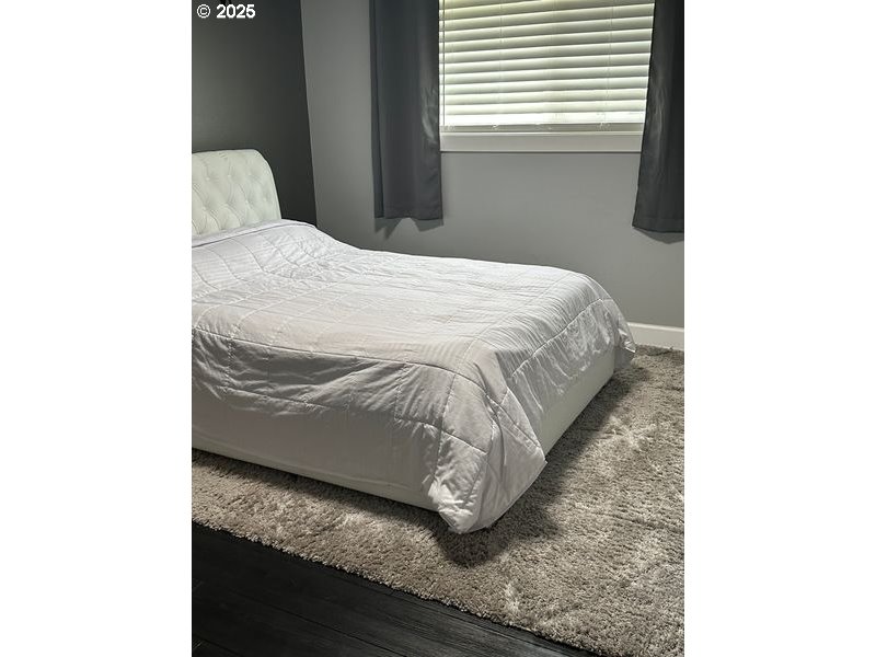 711 1st Street Brookings, OR 97415 - Photo 14 of 21 a bedroom with a bed and a window