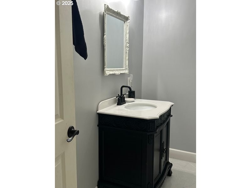 711 1st Street Brookings, OR 97415 - Photo 15 of 21 a bathroom with a sink and a mirror