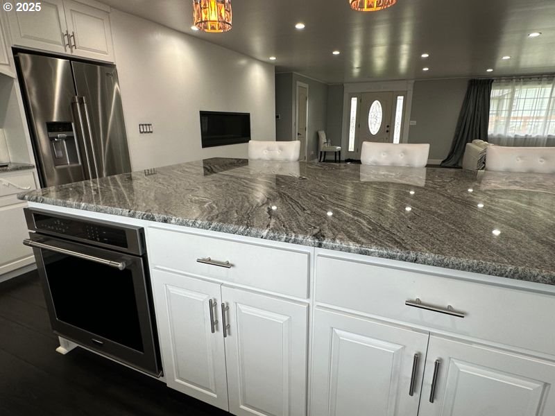 711 1st Street Brookings, OR 97415 - Photo 8 of 21 a kitchen with kitchen island granite countertop counter top space cabinets and stainless steel appliances