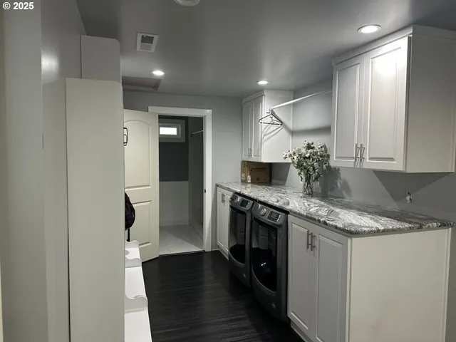 a bathroom with a granite countertop sink a toilet and a mirror