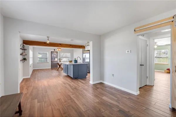 a view of a room with wooden floor and a window