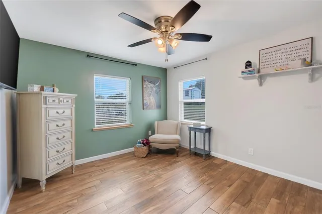 a living room with furniture and paintings on the wall
