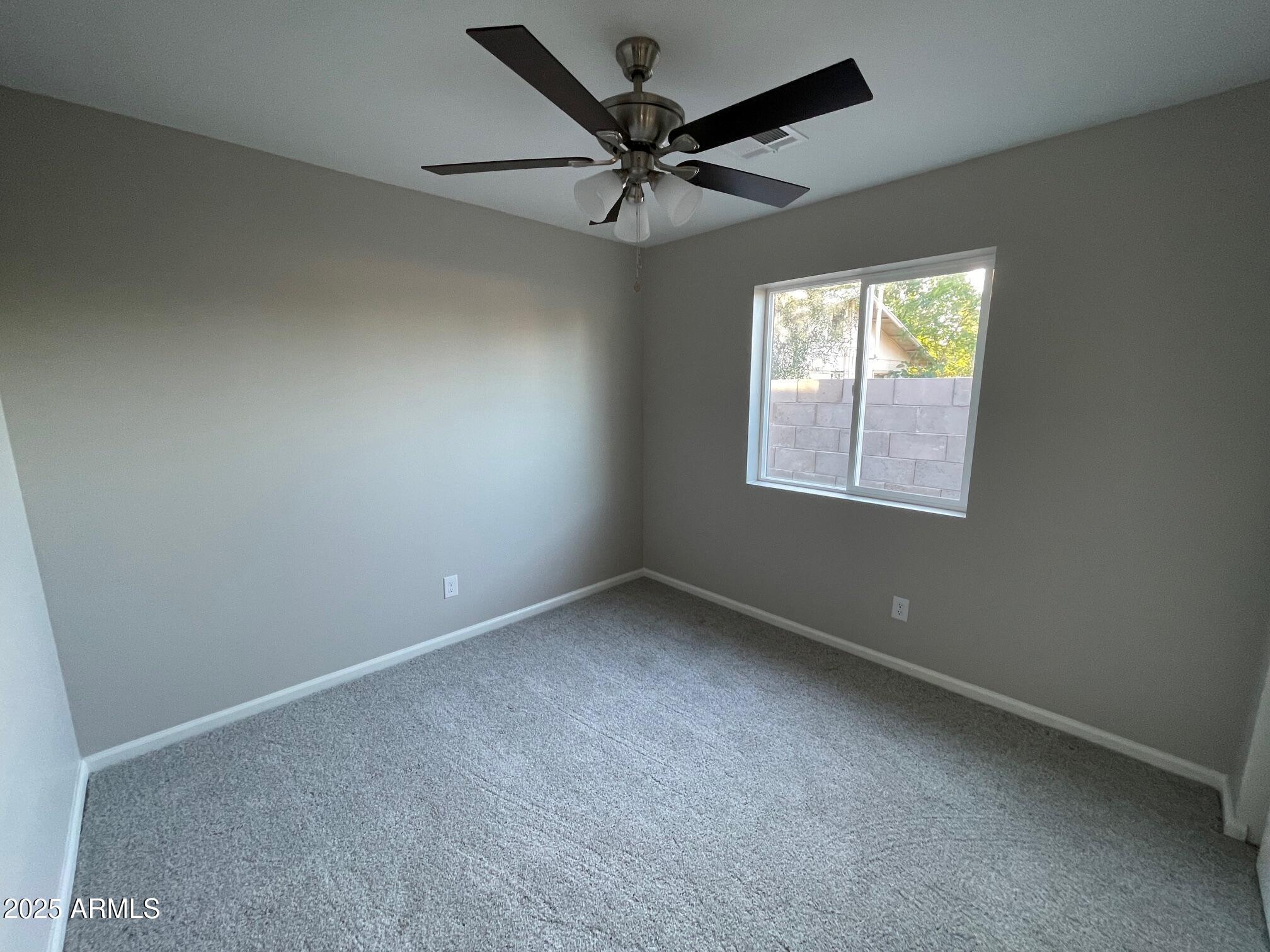 82 West Brooks Street Gilbert, AZ 85233 - Photo 17 of 23 an empty room with windows and ceiling fan