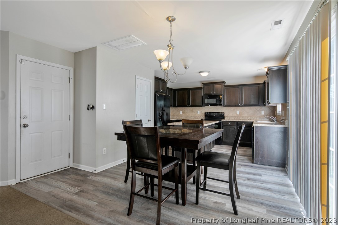 2040 Yellowbrick Road Fayetteville, NC 28314 - Photo 14 of 50 a view of a dining room and kitchen with a table chairs