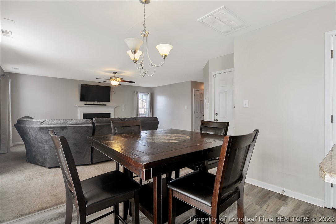 2040 Yellowbrick Road Fayetteville, NC 28314 - Photo 15 of 50 a view of a dining room with furniture and wooden floor