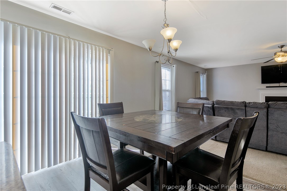 2040 Yellowbrick Road Fayetteville, NC 28314 - Photo 16 of 50 a view of a dining room with furniture and wooden floor