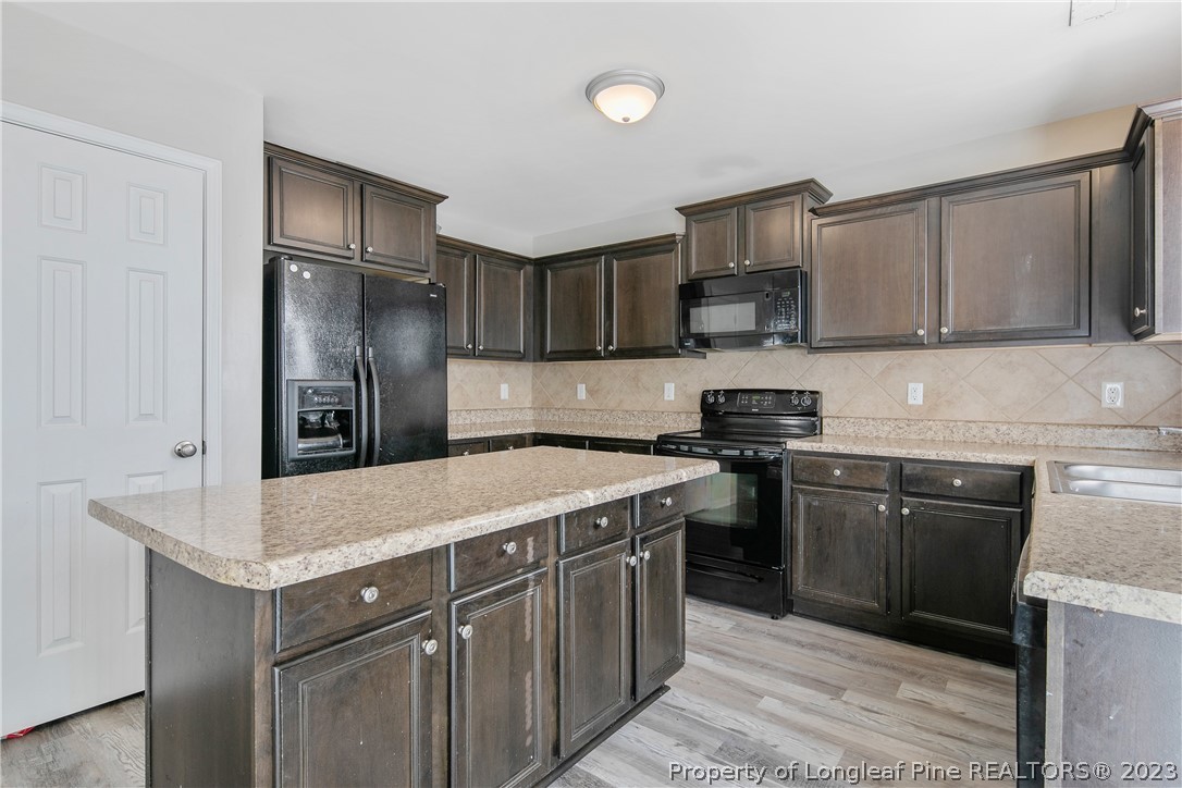 2040 Yellowbrick Road Fayetteville, NC 28314 - Photo 19 of 50 a kitchen with a refrigerator sink and cabinets