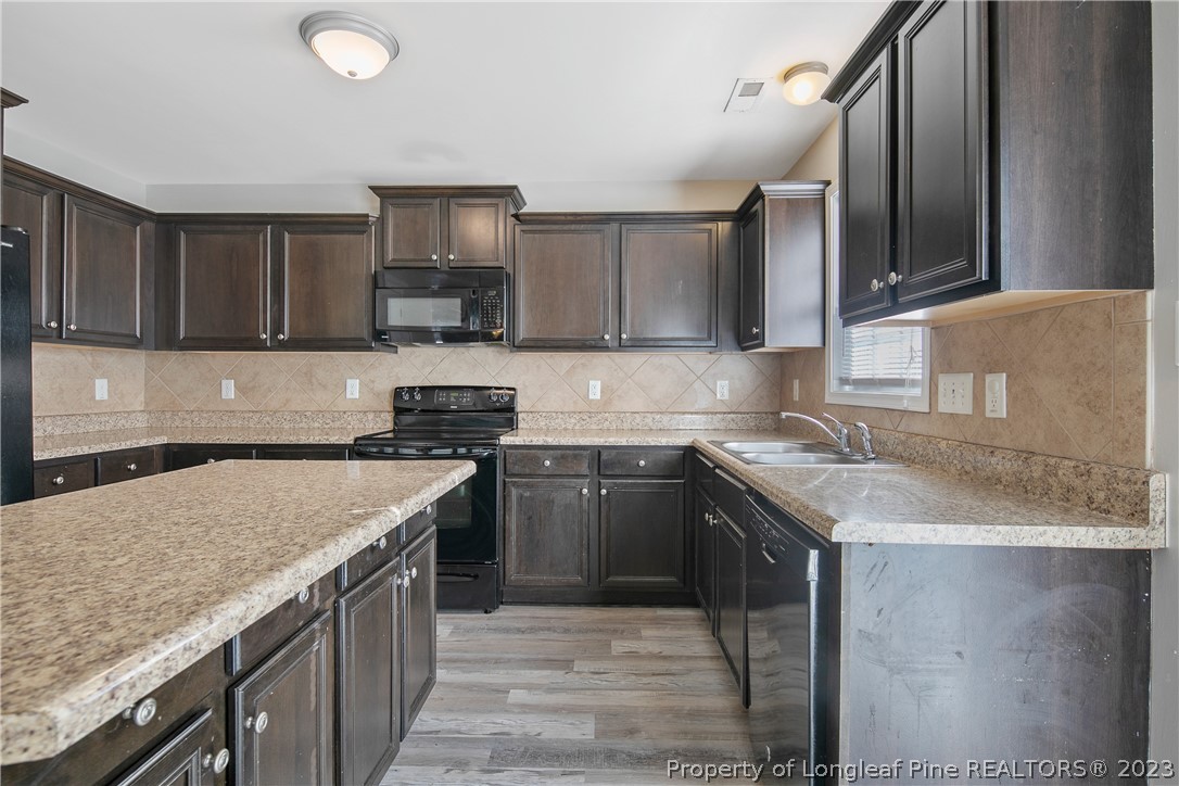 2040 Yellowbrick Road Fayetteville, NC 28314 - Photo 20 of 50 a kitchen with granite countertop a sink and a stove