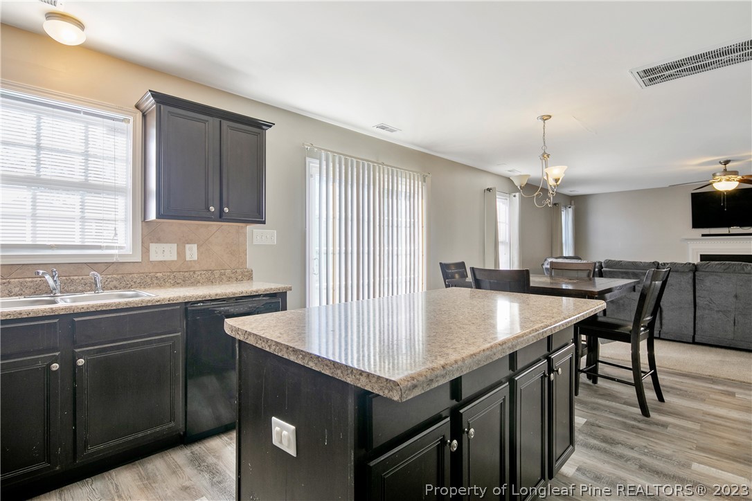 2040 Yellowbrick Road Fayetteville, NC 28314 - Photo 23 of 50 a kitchen with a sink a stove and cabinets