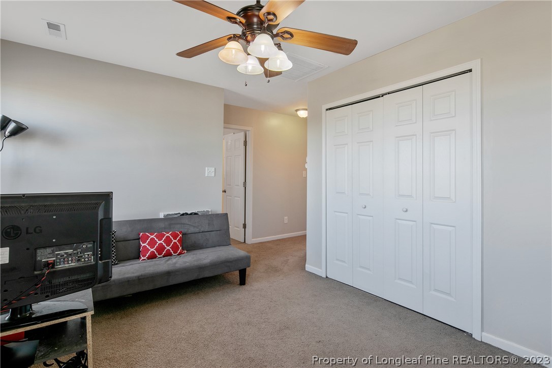 2040 Yellowbrick Road Fayetteville, NC 28314 - Photo 24 of 50 a living room with furniture and a ceiling fan
