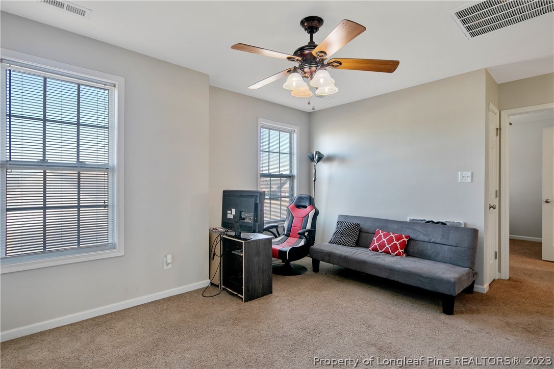 2040 Yellowbrick Road Fayetteville, NC 28314 - Photo 26 of 50 a living room with furniture and a ceiling fan