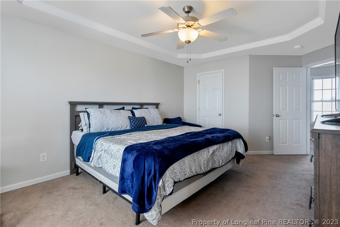 2040 Yellowbrick Road Fayetteville, NC 28314 - Photo 30 of 50 a bedroom with a bed and a chandelier