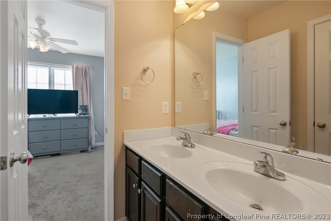 2040 Yellowbrick Road Fayetteville, NC 28314 - Photo 41 of 50 a bathroom with a double vanity sink and mirror