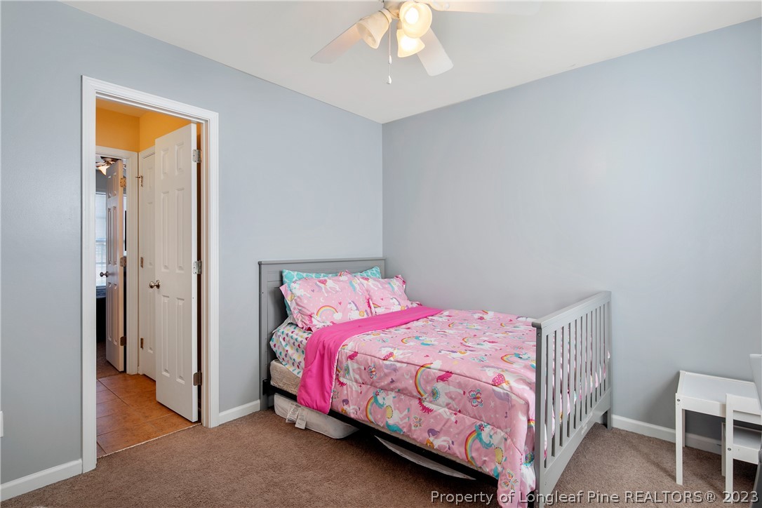 2040 Yellowbrick Road Fayetteville, NC 28314 - Photo 45 of 50 a bedroom with a bed and a chandelier