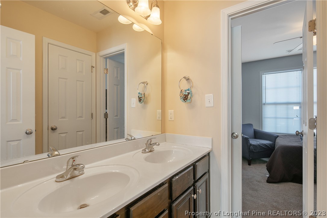 2040 Yellowbrick Road Fayetteville, NC 28314 - Photo 46 of 50 a bathroom with a sink double vanity and a mirror