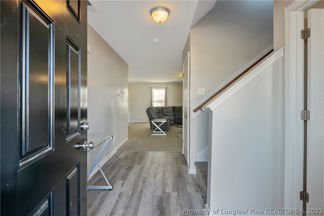 2040 Yellowbrick Road Fayetteville, NC 28314 - Photo 5 of 50 a view of a hallway view with wooden floor and staircase