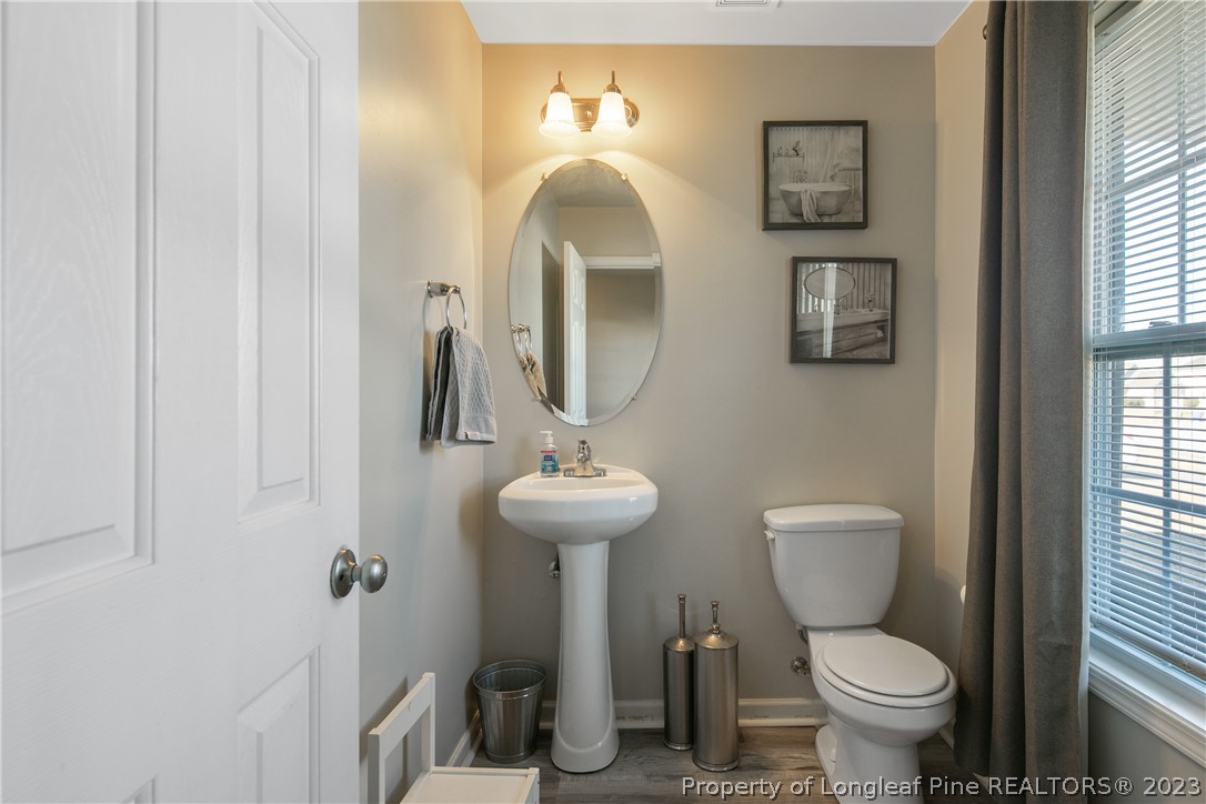 2040 Yellowbrick Road Fayetteville, NC 28314 - Photo 8 of 50 a bathroom with a toilet sink and mirror