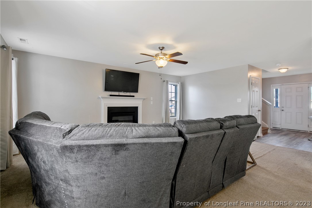 2040 Yellowbrick Road Fayetteville, NC 28314 - Photo 10 of 50 a living room with furniture a flat screen tv and a fireplace