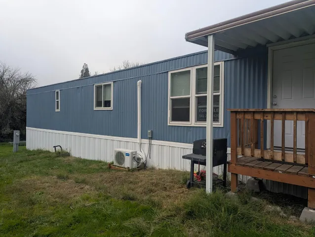 a backyard of a house with table and chairs
