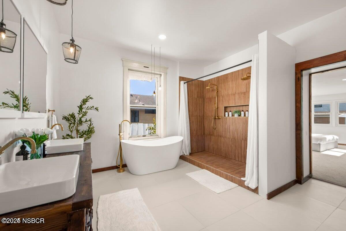 215 South H Street Lompoc, CA 93436 - Photo 11 of 24 a living room with a couch and a potted plant