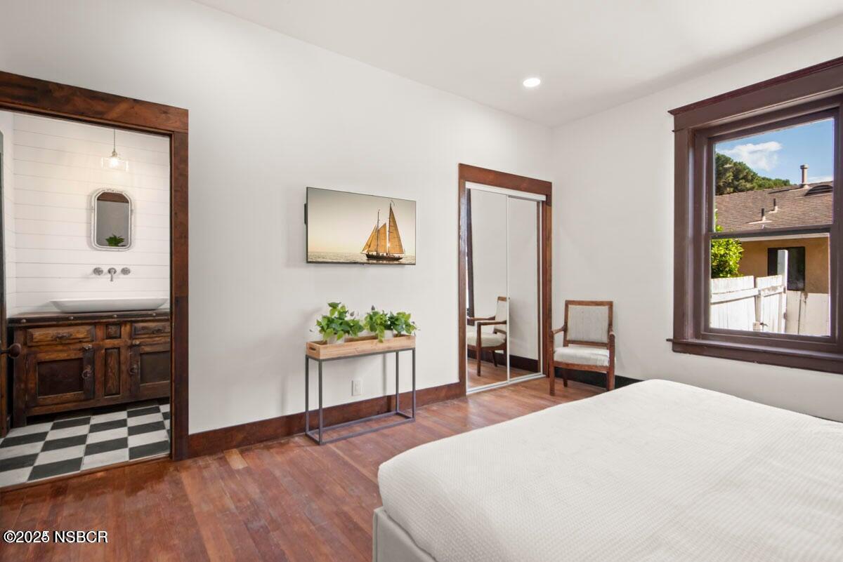 215 South H Street Lompoc, CA 93436 - Photo 14 of 24 a bedroom with a bed and dresser with mirror