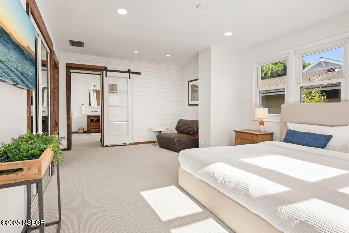 215 South H Street Lompoc, CA 93436 - Photo 9 of 24 a bedroom with a bed large window and furniture