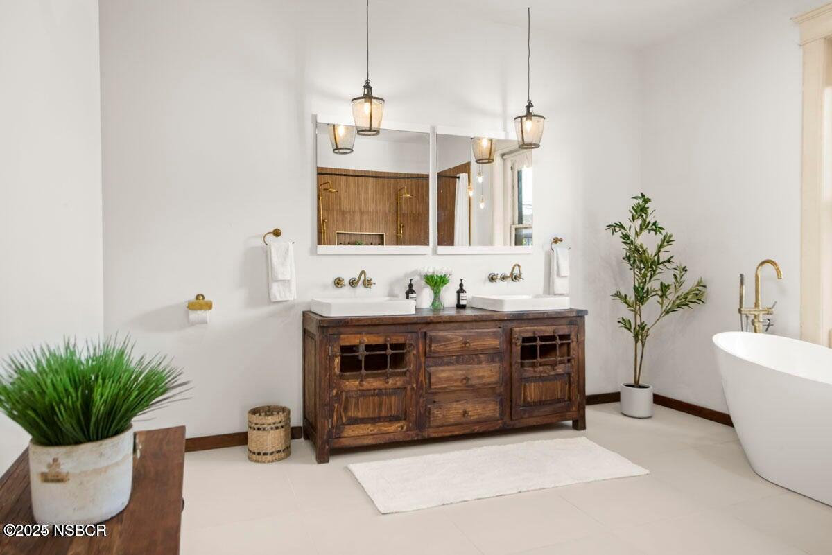 215 South H Street Lompoc, CA 93436 - Photo 10 of 24 a bathroom with a sink and a potted plant