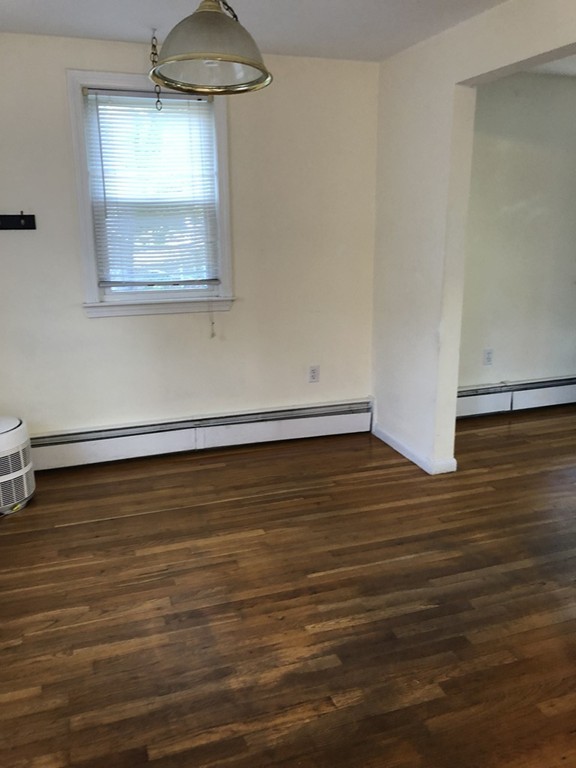 27 George Road, Unit 27 Winchester, MA 01890 - Photo 19 of 30 a view of a room with wooden floor and a window