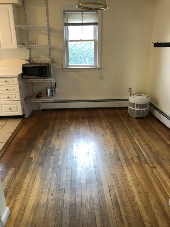 27 George Road, Unit 27 Winchester, MA 01890 - Photo 20 of 30 a view of a room with wooden floor and furniture