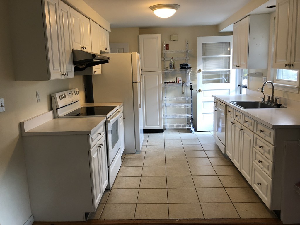 27 George Road, Unit 27 Winchester, MA 01890 - Photo 23 of 30 a kitchen with stainless steel appliances a refrigerator sink and stove