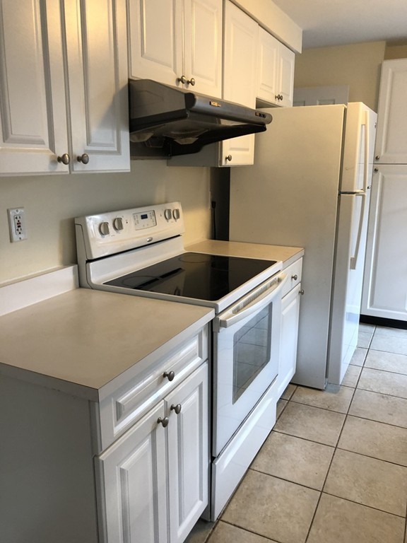 27 George Road, Unit 27 Winchester, MA 01890 - Photo 24 of 30 a kitchen with stainless steel appliances a refrigerator and a stove