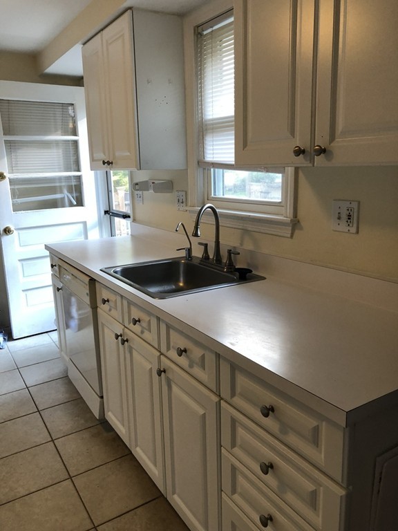 27 George Road, Unit 27 Winchester, MA 01890 - Photo 25 of 30 a kitchen with stainless steel appliances a sink stove and cabinets