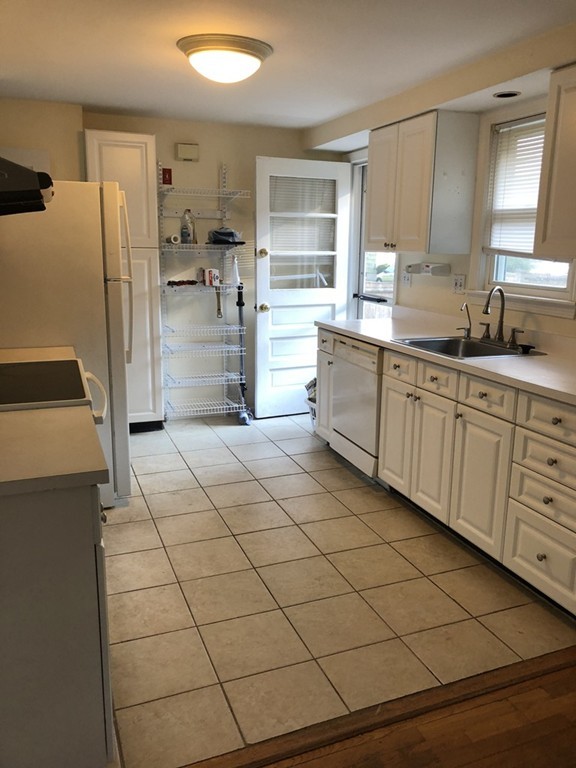 27 George Road, Unit 27 Winchester, MA 01890 - Photo 26 of 30 a kitchen with stainless steel appliances a refrigerator sink and cabinets