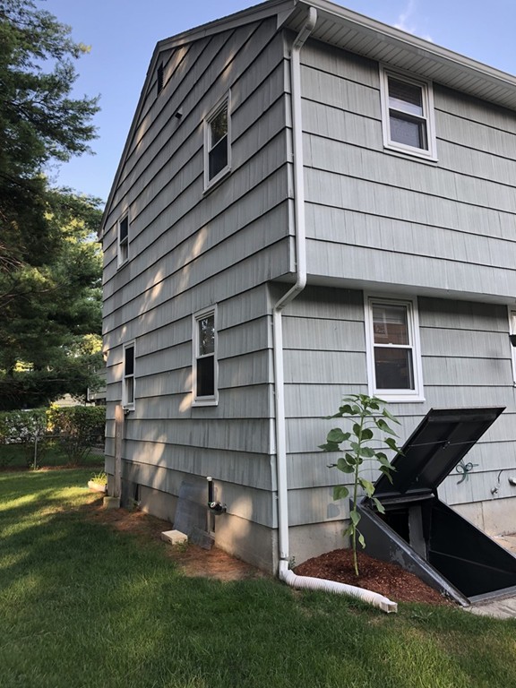 27 George Road, Unit 27 Winchester, MA 01890 - Photo 28 of 30 a front view of a house with a yard