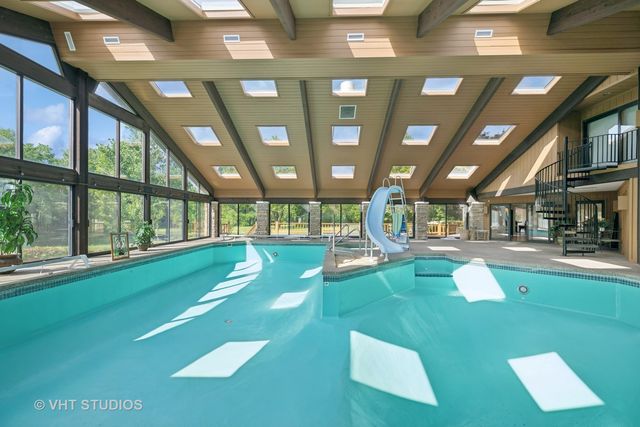 a view of a patio with couches potted plants and a big yard