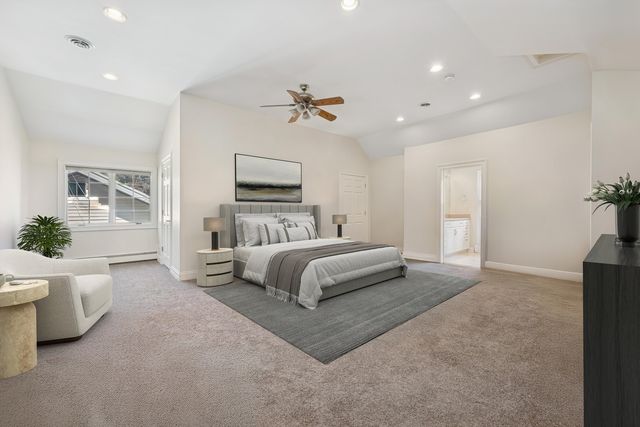 a bedroom with a large bed and wooden floor