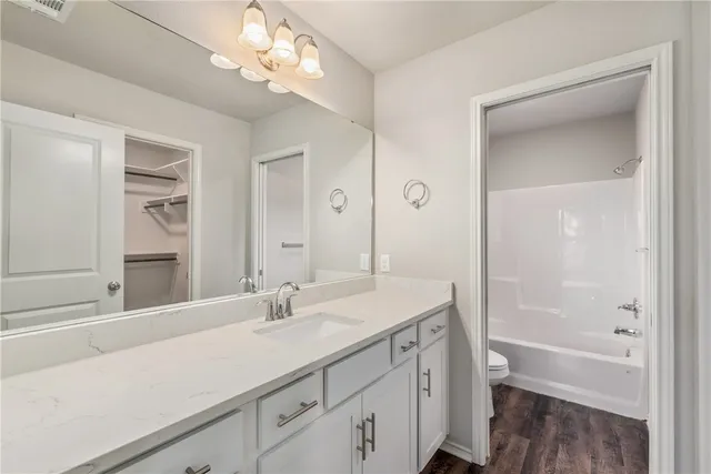 a bathroom with a sink a vanity and a mirror